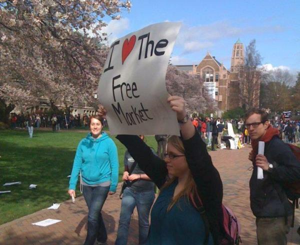 Mikayla holds up a sign on campus.